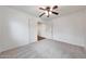 Bright bedroom with plush carpeting, white walls, and a ceiling fan for a comfortable living space at 16540 W Culver St, Goodyear, AZ 85338