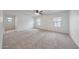Spacious bedroom with carpet, ceiling fan and two windows providing natural light at 16540 W Culver St, Goodyear, AZ 85338