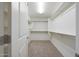 Walk-in closet with carpet flooring, wire shelving, and white walls to keep everything organized at 16540 W Culver St, Goodyear, AZ 85338