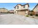 Lovely house features a spacious driveway leading to an attached garage, complemented by desert landscaping at 16540 W Culver St, Goodyear, AZ 85338