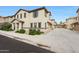 Charming two-story home with landscaped front yard and a private driveway leading to a garage at 16540 W Culver St, Goodyear, AZ 85338