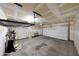 Spacious two car garage with high ceilings, storage racks, and garage door at 16540 W Culver St, Goodyear, AZ 85338