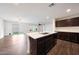 Modern kitchen features stainless steel appliances, an island and overlooks the living room at 16540 W Culver St, Goodyear, AZ 85338