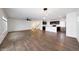 Spacious living area features wood floors, ceiling fan, and open floor plan to the kitchen and staircase at 16540 W Culver St, Goodyear, AZ 85338