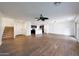 Open living area features wood floors, modern light fixtures, ceiling fan, and staircase at 16540 W Culver St, Goodyear, AZ 85338