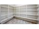 This walk-in pantry offers tons of shelving to store your dry goods and other essentials at 16540 W Culver St, Goodyear, AZ 85338