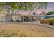 Backyard with covered patio area, outdoor seating, and spacious dirt yard framed by mature trees at 1712 E Montebello Ave, Phoenix, AZ 85016