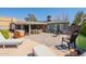 Backyard with brick-paved patio area, outdoor seating, and a spacious sitting area with a gray privacy fence at 1712 E Montebello Ave, Phoenix, AZ 85016