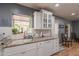 The well-appointed kitchen features white cabinetry, granite counters, ample counter space, and updated appliances at 1712 E Montebello Ave, Phoenix, AZ 85016