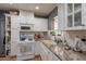 Well-lit kitchen featuring white cabinets, granite countertops, and stainless steel appliances for a sleek design at 1712 E Montebello Ave, Phoenix, AZ 85016
