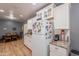 Traditional kitchen featuring white cabinets, stainless steel appliances, wood laminate flooring, and painted gray walls at 1712 E Montebello Ave, Phoenix, AZ 85016