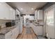 Bright, renovated kitchen with white cabinetry, modern appliances, and hardwood floors; a chef's dream at 1712 E Montebello Ave, Phoenix, AZ 85016