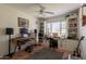 A home office with built-in shelves and desk space with large windows and guitars hanging on the wall at 1712 E Montebello Ave, Phoenix, AZ 85016