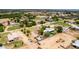 This aerial view of the property reveals its generous lot, pool, landscaping, and proximity to other residences at 18051 E Happy Rd, Queen Creek, AZ 85142