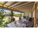 Charming covered back patio with outdoor seating, perfect for relaxing and enjoying the landscaped backyard view at 18051 E Happy Rd, Queen Creek, AZ 85142