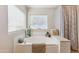 Soaking tub nestled between subway tile with decorative accents and bright natural light at 18051 E Happy Rd, Queen Creek, AZ 85142