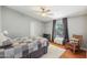 Comfortable bedroom featuring hardwood floors, neutral colors, and a rocking chair at 18051 E Happy Rd, Queen Creek, AZ 85142
