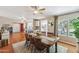 Inviting dining room featuring wood floors, large windows, and stylish ceiling fan, perfect for Gathering gatherings at 18051 E Happy Rd, Queen Creek, AZ 85142