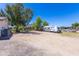 Large driveway and parking area with RV hookups, perfect for accommodating multiple vehicles and recreational equipment at 18051 E Happy Rd, Queen Creek, AZ 85142