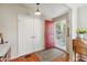 Bright foyer featuring a red front door and wood flooring at 18051 E Happy Rd, Queen Creek, AZ 85142