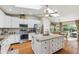 Gourmet kitchen with stainless steel appliances, center island, and a breakfast nook with natural light at 18051 E Happy Rd, Queen Creek, AZ 85142