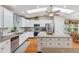 Bright kitchen with skylights, white cabinetry, stainless appliances, and granite countertops at 18051 E Happy Rd, Queen Creek, AZ 85142