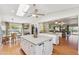 Expansive kitchen with an island and easy flow to dining and living areas creating an open design at 18051 E Happy Rd, Queen Creek, AZ 85142