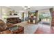 Comfortable living room with a large screen TV and access to the patio at 18051 E Happy Rd, Queen Creek, AZ 85142