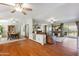 Spacious living space featuring hardwood floors, a ceiling fan and backyard views at 18051 E Happy Rd, Queen Creek, AZ 85142