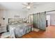 Spacious main bedroom featuring hardwood floors and barn-door access to an ensuite bathroom at 18051 E Happy Rd, Queen Creek, AZ 85142