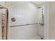 Shower detailed with white subway tile, shower head, and accessible handrails at 18051 E Happy Rd, Queen Creek, AZ 85142
