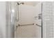 Shower detailed with white subway tile, shower head, and accessible handrails at 18051 E Happy Rd, Queen Creek, AZ 85142
