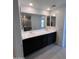 Elegant bathroom with dual sinks, dark cabinetry, and quartz countertops at 18183 W Larkspur Dr, Goodyear, AZ 85338