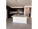 Modern kitchen features dark cabinets, stainless appliances, and a large center island at 18183 W Larkspur Dr, Goodyear, AZ 85338