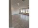 Expansive living room with tile flooring and lots of natural light from many windows at 18183 W Larkspur Dr, Goodyear, AZ 85338