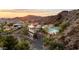 Aerial view of a hillside house featuring a pool, offering breathtaking views of the city and surrounding mountains at 1836 E Turquoise Ave, Phoenix, AZ 85020