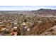 An aerial view of a neighborhood nestled in the mountains, showcasing lush landscapes and unique residential architecture at 1836 E Turquoise Ave, Phoenix, AZ 85020