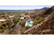 Aerial view of a hillside house featuring a pool, offering breathtaking views of the city and surrounding mountains at 1836 E Turquoise Ave, Phoenix, AZ 85020