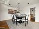Stylish dining room with elegant chandelier and seating for six around dark wood table at 1836 E Turquoise Ave, Phoenix, AZ 85020