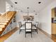 Modern dining room featuring a chandelier, a view of staircase and a dining table set for six at 1836 E Turquoise Ave, Phoenix, AZ 85020