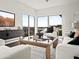 Bright living room with a TV and large windows that offer panoramic views of the city and mountains at 1836 E Turquoise Ave, Phoenix, AZ 85020