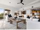 Spacious living room with plush seating, ceiling fan, and a large window at 1836 E Turquoise Ave, Phoenix, AZ 85020
