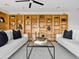 Inviting living room with built-in bookshelves, dual sofas, and sleek glass coffee table at 1836 E Turquoise Ave, Phoenix, AZ 85020