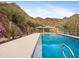 A beautiful backyard pool with mountain views and lush desert landscaping at 1836 E Turquoise Ave, Phoenix, AZ 85020