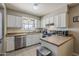 Bright kitchen featuring white cabinets, stainless steel appliances, and tile flooring at 1838 E 2Nd Pl, Mesa, AZ 85203