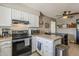 Spacious kitchen with white cabinets, modern appliances, and a kitchen island at 1838 E 2Nd Pl, Mesa, AZ 85203