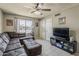 Comfortable living room with a sectional sofa, ceiling fan, and tile flooring at 1838 E 2Nd Pl, Mesa, AZ 85203