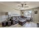Inviting living room featuring a large sectional sofa, ceiling fan, and tile flooring at 1838 E 2Nd Pl, Mesa, AZ 85203
