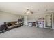 Open-concept living room with neutral carpet, ceiling fan, and access to other rooms at 1838 E 2Nd Pl, Mesa, AZ 85203