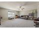 Spacious living room with neutral tones, a ceiling fan, and large windows for natural light at 1838 E 2Nd Pl, Mesa, AZ 85203